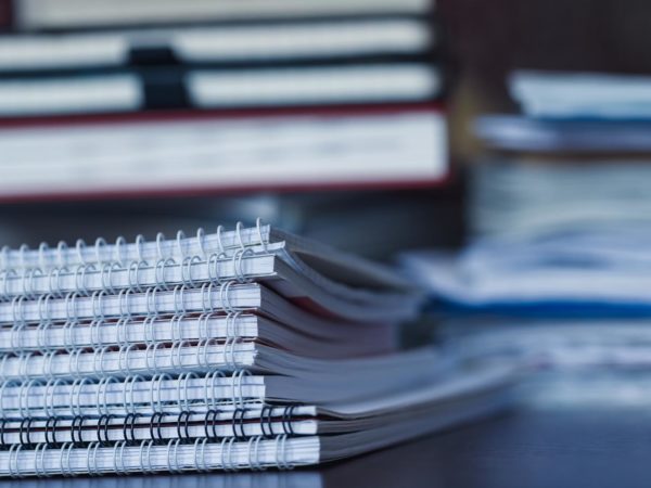 Accounting and taxes Accounting and taxes. Large pile of magazine, notebook and books closeup